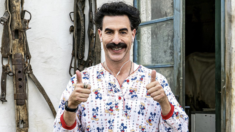 Borat in Mickey Mouse pyjamas giving two thumbs up in Borat Subsequent Moviefilm