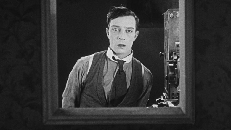 The projectionist looks around with concern in "Sherlock Jr." (1921)