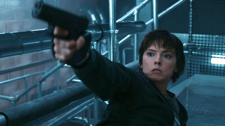 Locke slides across the floor and aims a gun in "Cleaner" (2025)