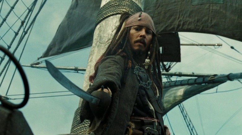 Jack Sparrow draws his sword while clinging to the mast in "Pirates of the Caribbean: Dead Man's Chest" (2006)