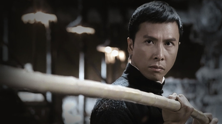 Ip Man holds a staff and prepares to fight in "Ip Man" (2008)
