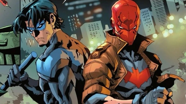 Nightwing and Red Hood standing back to back ready to fight