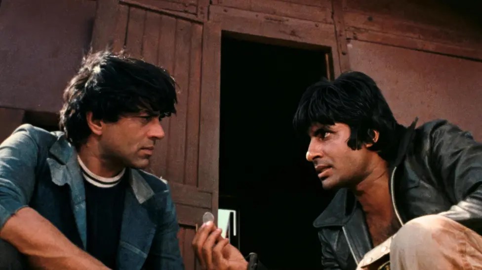 Two men about to flip a coin; Dharmendra and Amitabh Bachchan in 'Sholay'