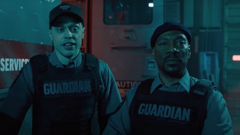 Russell and Travis standing by truck in The Pickup
