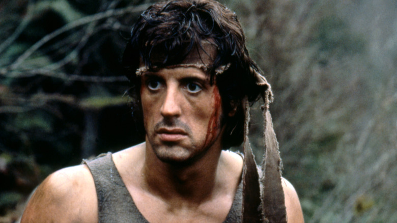 Rambo bleeding in the woods in "First Blood" (1982)