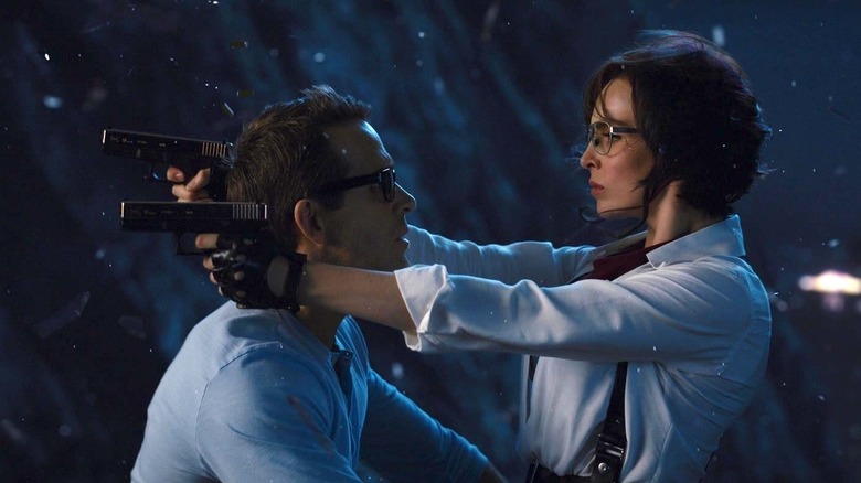 MolotovGirl aiming her guns over Guy's shoulders in Free Guy (2021)