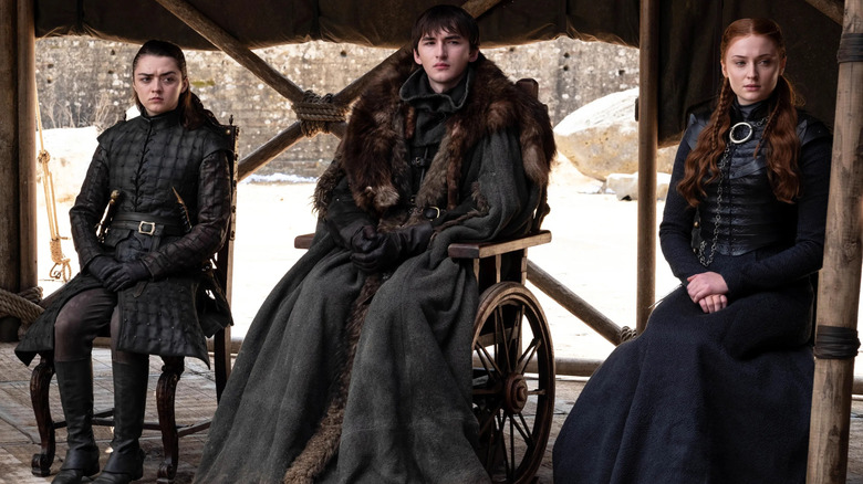 Arya, Bran, and Sansa Stark sit together, unimpressed, in "Game of Thrones"