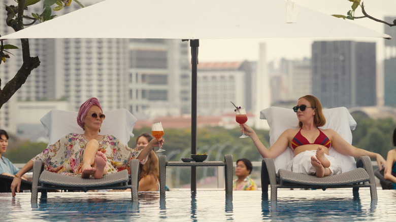 Deborah (Jean Smart) and Ava (Hannah Einbinder) luxuriating together by the pool at a swanky hotel on "Hacks"