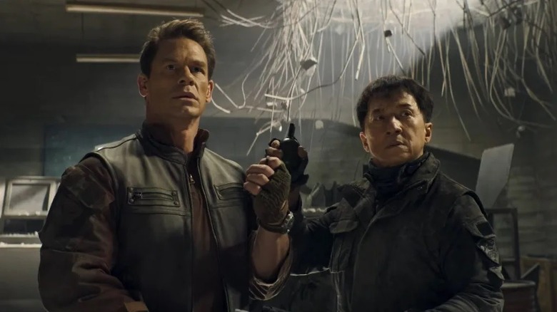 Dragon and Chris hold grenades in a dark room in "Hidden Strike" (2023)