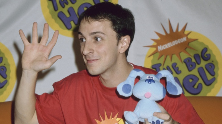 Young Steve Burns waving and holding Blue