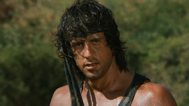 Rambo stands in the forest in "Rambo: First Blood Part II" (1985)