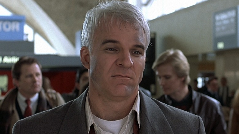 Neal Page confronts a car rental clerk in "Planes, Trains and Automobiles" (1987)