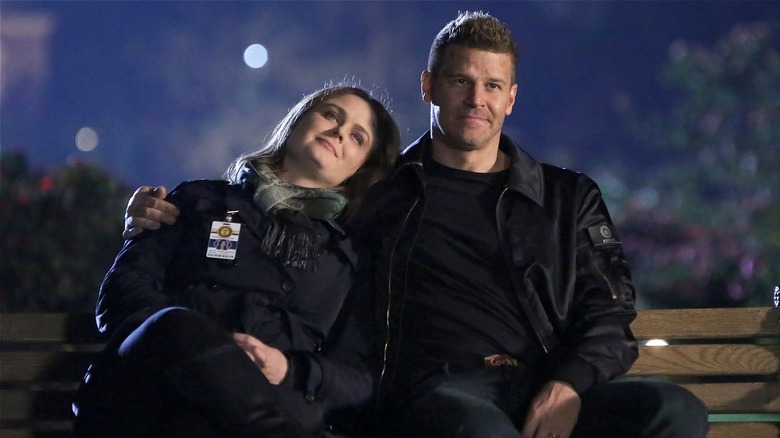 Brennan and Booth sitting on a bench in "Bones" (2017)