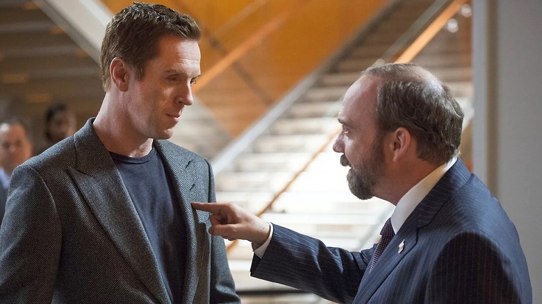 Rhoades confronts Axelrod and points a finger at his chest in Billions