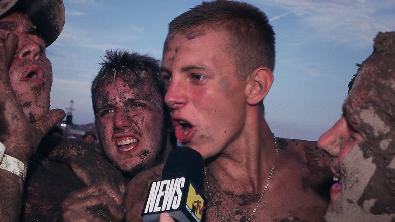 Revelers at Woodstock '99 talking into mic on Trainwreck: Woodstock '99 (2022)
