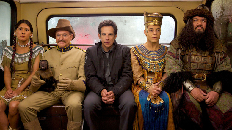 Sacajawea, Roosevelt, Larry, Ahkmenrah, and Attila sitting in a bus in "Night at the Museum: Secret of the Tomb" (2014)
