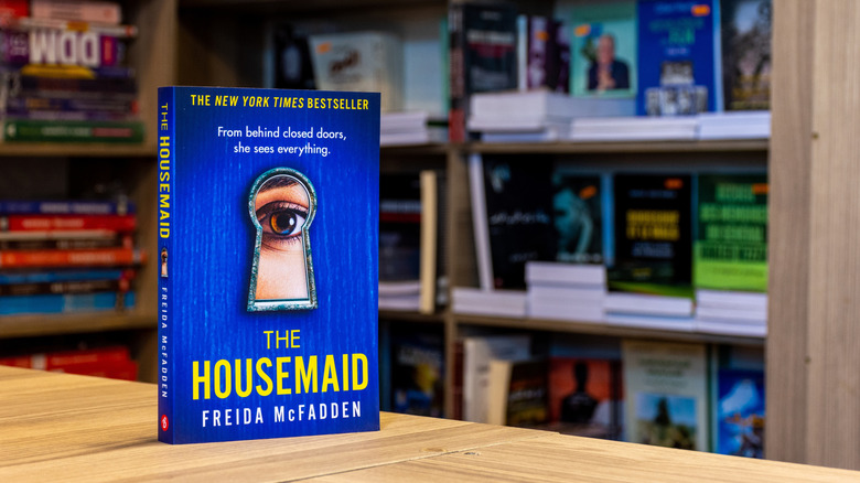 The Housemaid book in front of a bookshelf