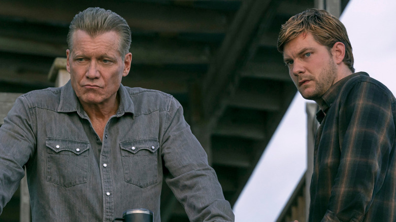 Harlan and Cane stand over a railing in "The Waterfront" (2025)