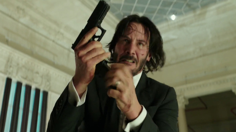 John Wick loads a gun in "John Wick" (2014)