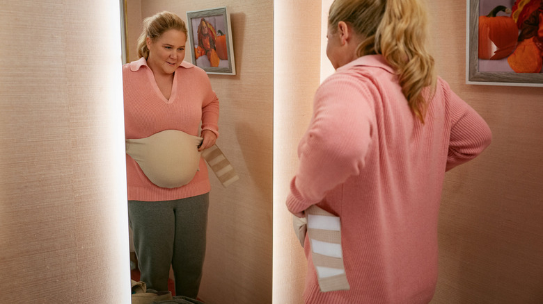 Lainey Newton preparing her pregnancy facade in Kinda Pregnant (2025)