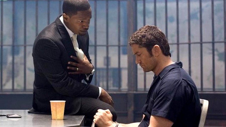 Shelton sits handcuffed in an interrogation room while Rice talks to him in Law Abiding Citizen (2009)
