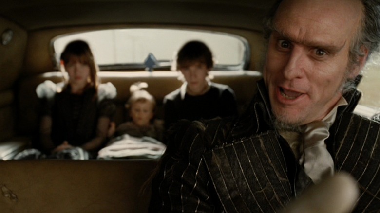 Count Olaf driving the Baudelaire children in "Lemony Snicket's A Series of Unfortunate Events" (2004)