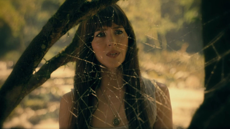 Madame Web looking at a spider web