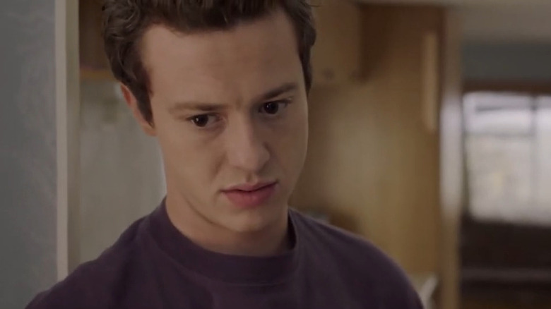 Tom looking serious in his caravan in "Make Up" (2020)