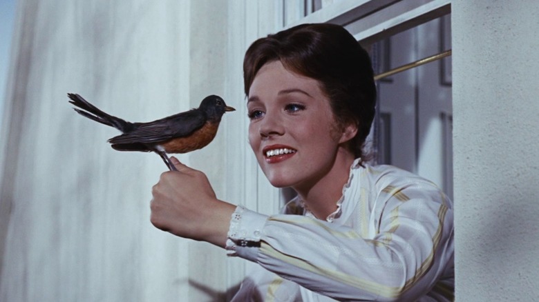 Mary Poppins holds a bird in "Mary Poppins" (1964)