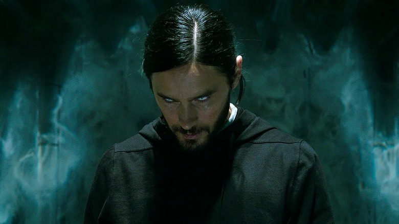 Morbius standing in the dark wearing a black jumper