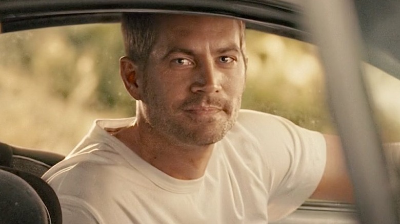 Brian O'Connor smiles behind the wheel in "Furious 7" (2015)