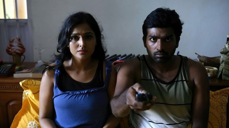 Michael Karthikeyan and his girlfriend inspect eerie footage in Pizza (2012)
