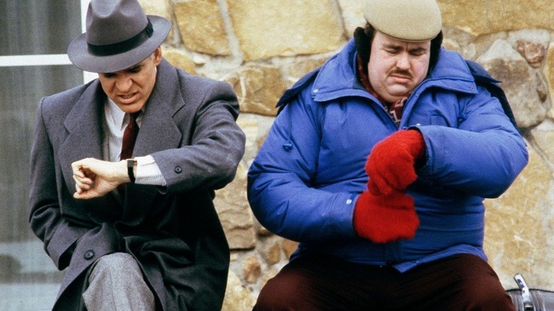 Neal and Del checking the time in Planes, Trains, and Automobiles