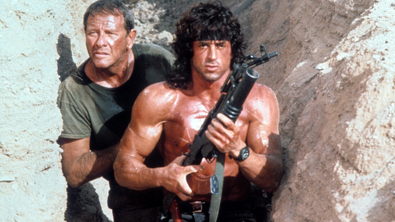 Trautman stands behind an armed Rambo in "Rambo III" (1988)