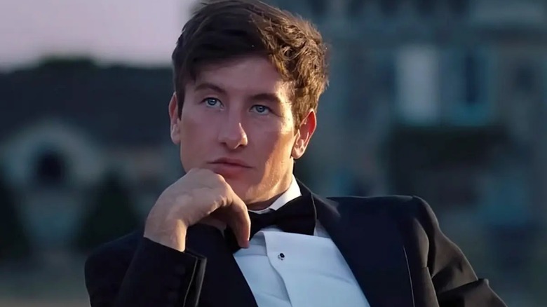 Oliver sits outside and schemes in Saltburn (2023)