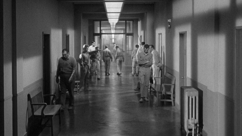 Patients standing in asylum hallway in "Shock Corridor" (1963)