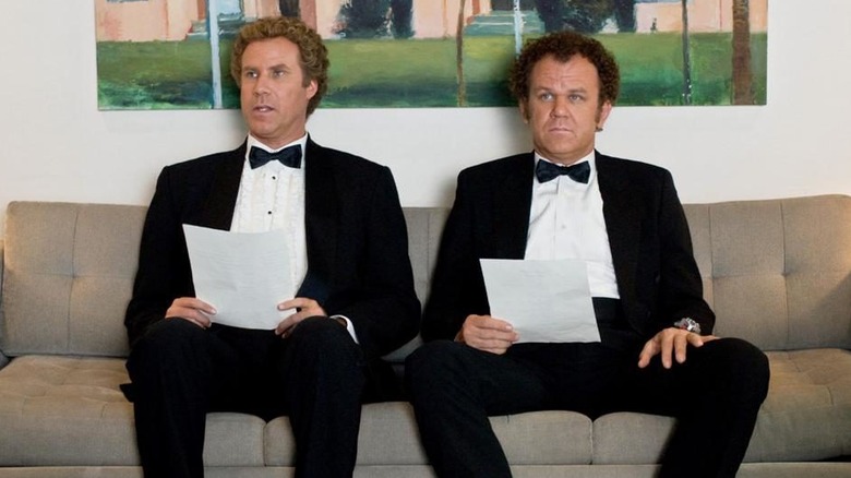 Brennan and Dale sitting on a couch in tuxes in Step Brothers (2008)