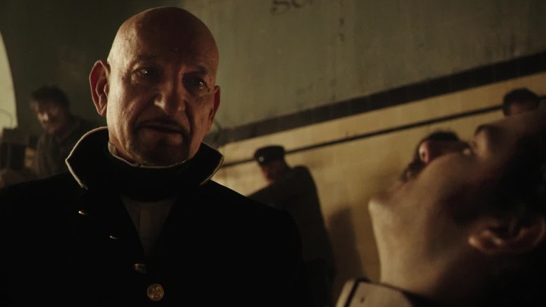 Dr. Lamb looking down at Dr. Newgate in "Stonehearst Asylum" (2014)