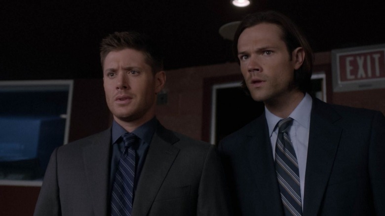 Sam and Dean Winchester standing in a theater in Supernatural (2005)