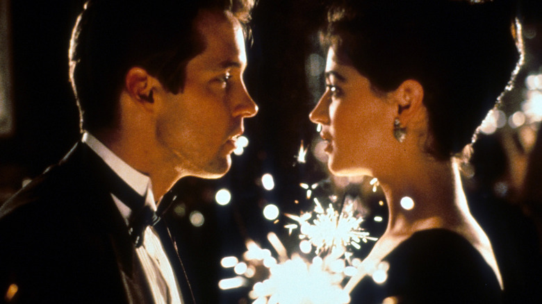 Doug and Kate look at each other while holding sparklers in "The Cutting Edge" (1992)