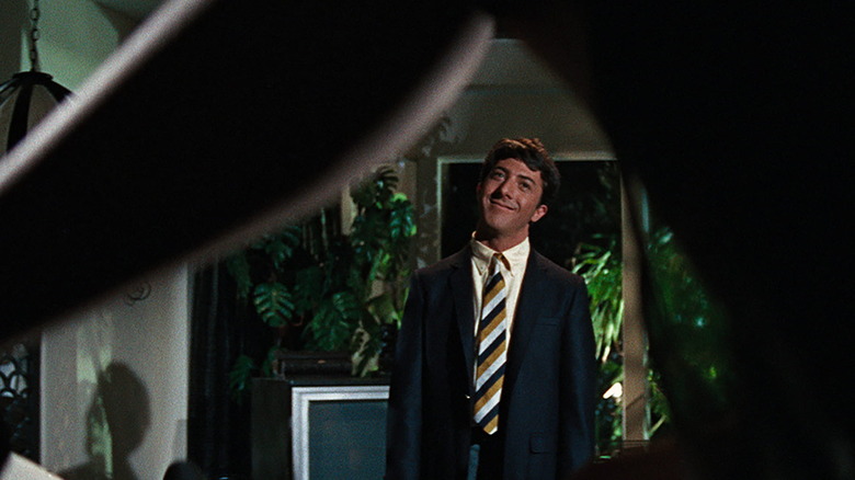 Benjamin looking under Mrs. Robinson's leg in The Graduate