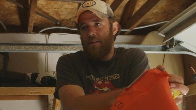 A man in a cap and Rolling Stones shirt being interviewed for the documentary "The Great Invisible" (2014)