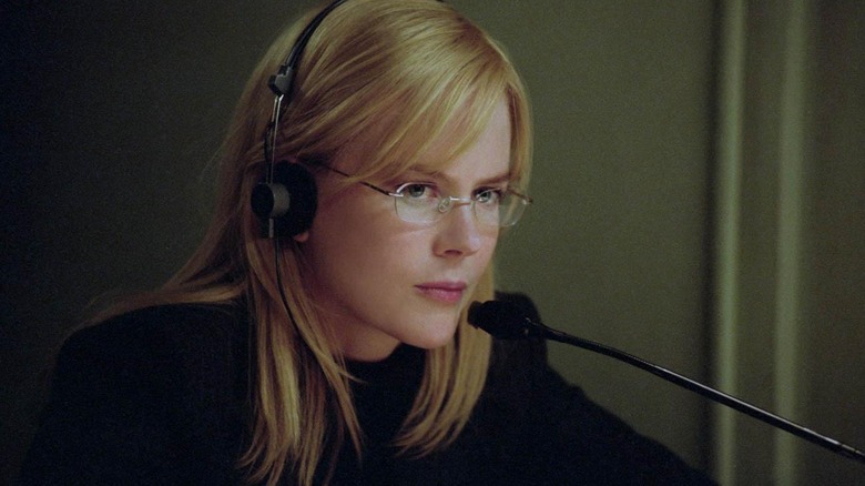 Bloom sits behind a mic with headphones on in The Interpeter (2005)