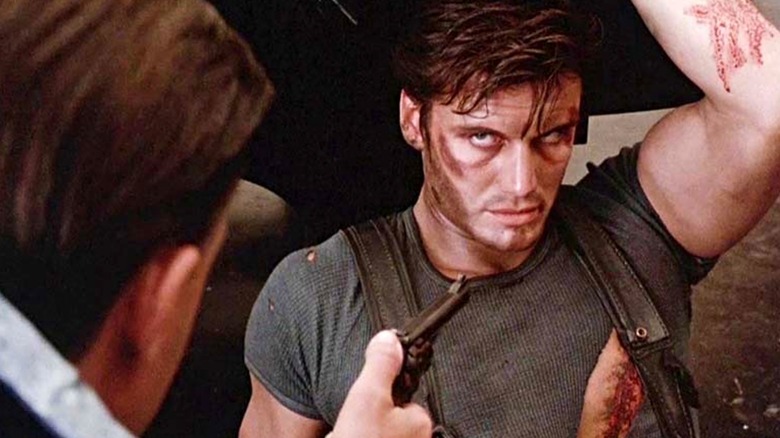 An injured Frank Castle being held at gunpoint