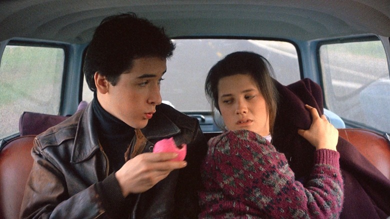 Walter in the back of a car with Alison in The Sure Thing