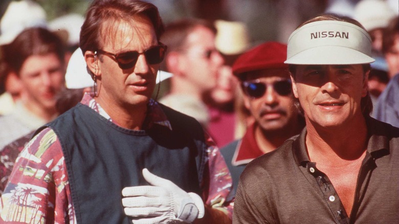 Roy in a white glove and David in a Nissan visor in "Tin Cup" (1996)