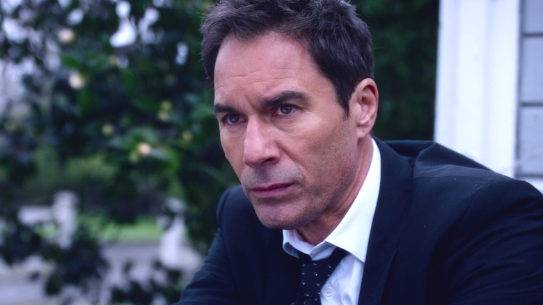 Grant MacLaren sitting on a step in "Travelers"