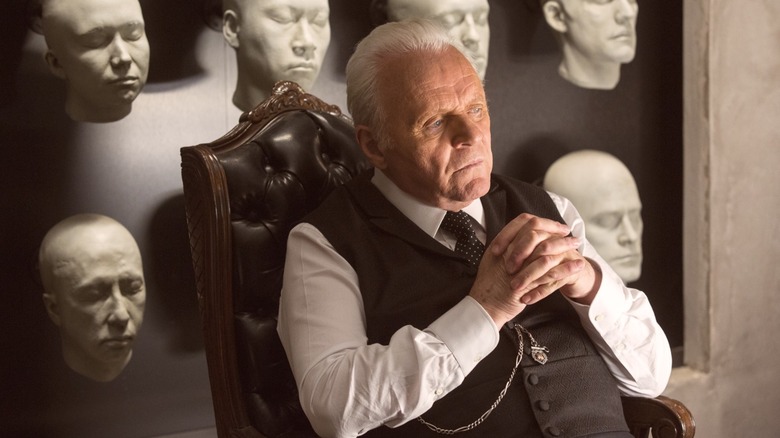 Dr. Robert Ford sitting in front of model heads in "Westworld"