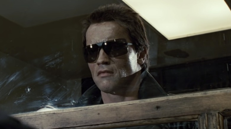The T-800 in sunglasses looking through a window in "The Terminator" (1984)