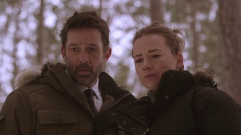 Cardinal and Lise look down at a dead body in "Cardinal" (2017-2020)